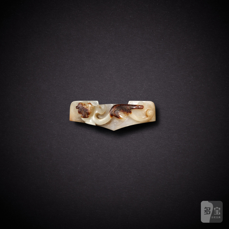 A white and russet jade 'chilong' sword guard, Han dynasty | 漢 白玉螭龍紋劍鐔